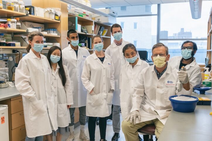 一群科学家戴着口罩，包括施普林格，在实验室里